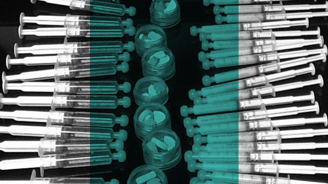 A patient’s kitchen counter at home filled with dozens of medication syringes and small containers with pills for the child’s medication regimen each day. 
