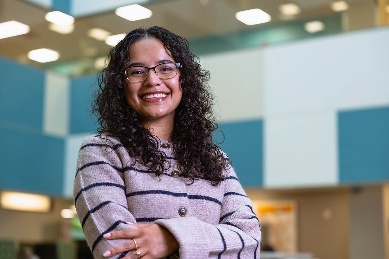 Adriana Jaime Castillo a Clinical Effectiveness Operations Coordinator smiling with arms crossed 