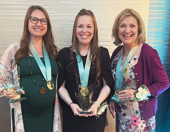 Group of nurses holding Nightingale Awards for for Nursing Excellence.