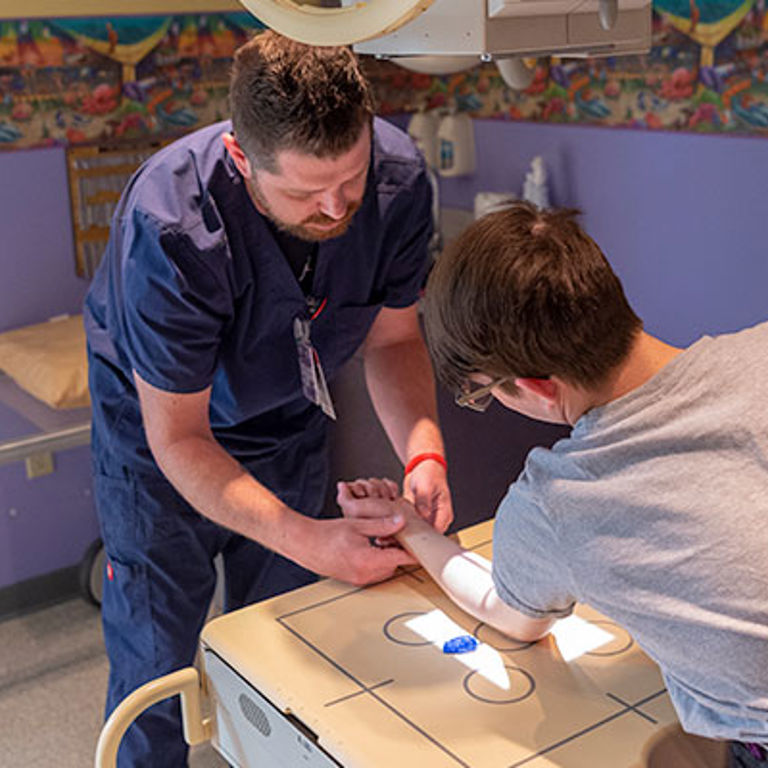 Nurse looking at patient's arm