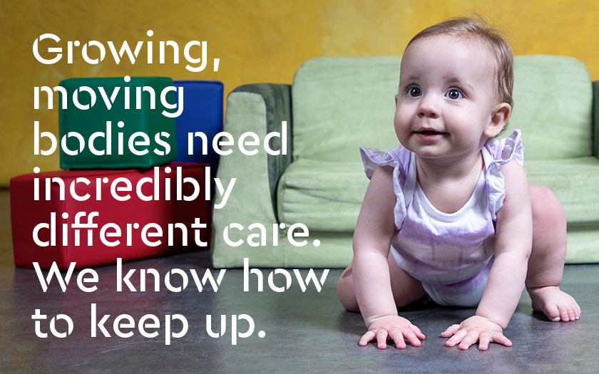  Baby Emma looking up at the camera and smiling.