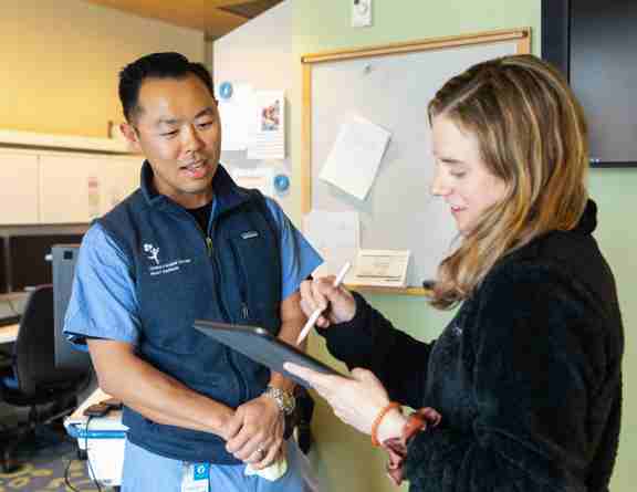 clinicians looking at a tablet 