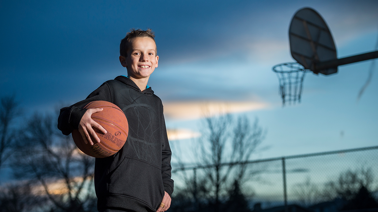 Young boy, Caleb, with a basketball.