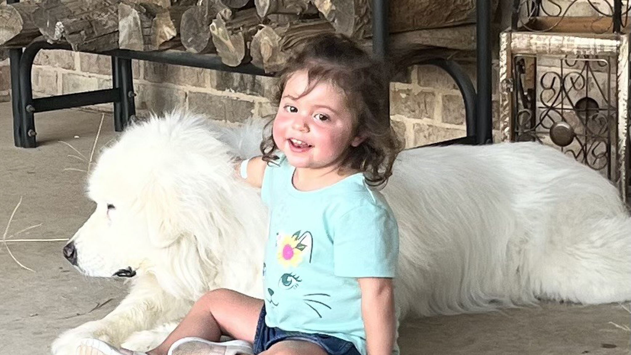 Emma plays with her dog after she got her liver transplant at Children’s Hospital Colorado.