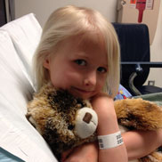 Isabella holds her teddy bear at Children's Hospital Colorado.