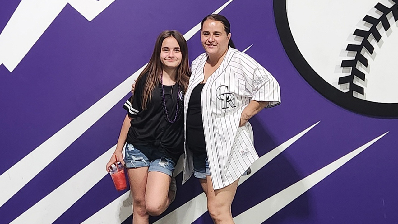 Jaycee smiles with her mom at a Colorado Rockies game with her mom.