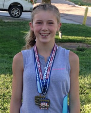Jessie stands tall with her champion medals hanging around her neck.