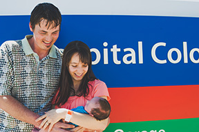 Noah's parents hold him in front of the Children's Hospital Colorado sign as they leave to take him home.