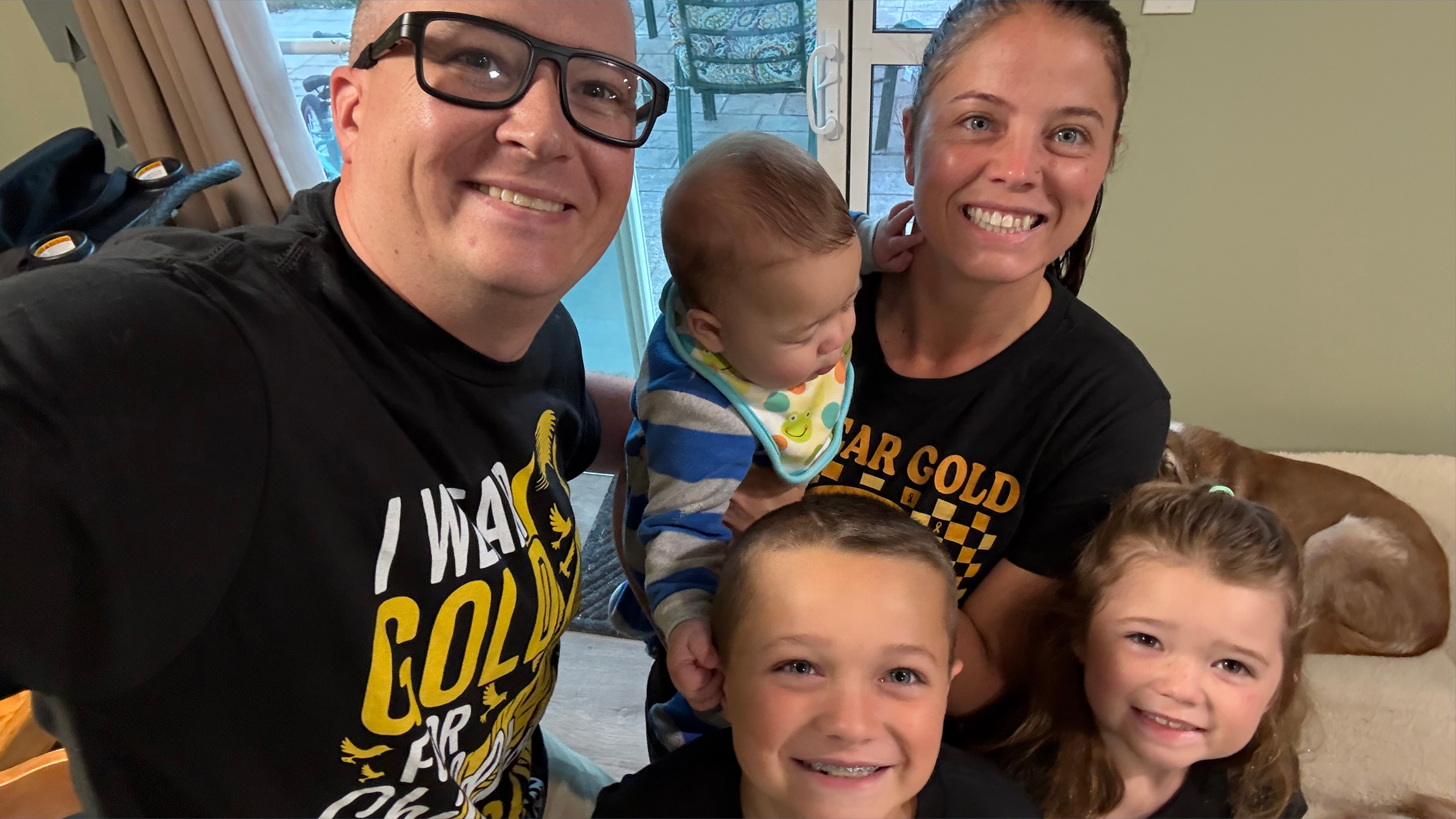 A family of five posing for a photo.