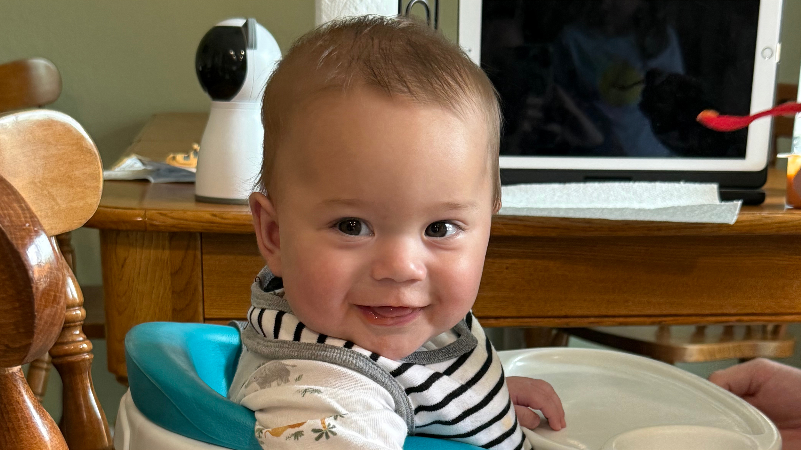 A baby smiling at the camera