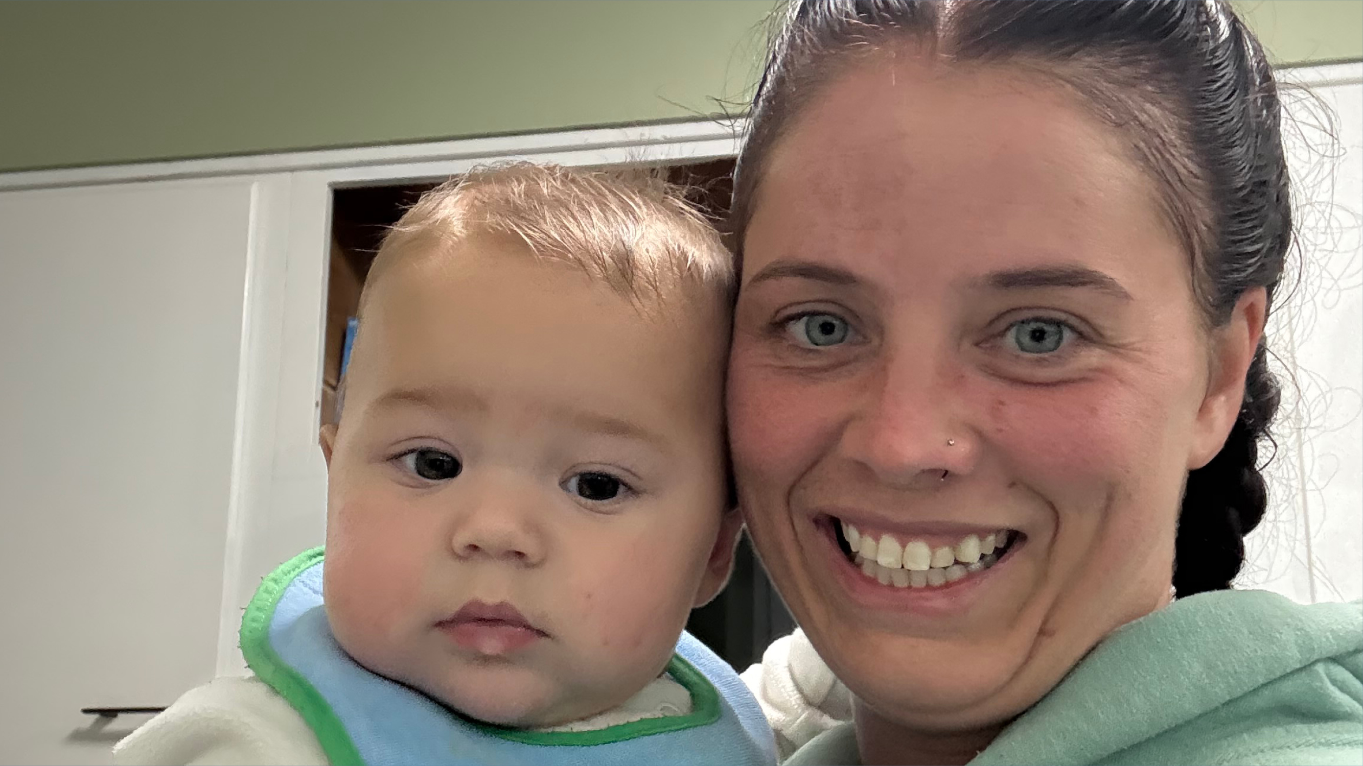 A mom and baby smiling