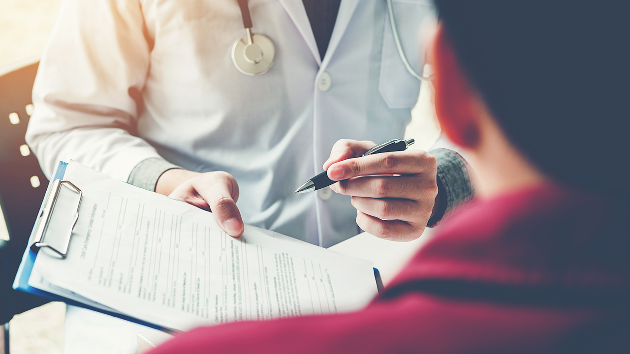 A provider explaining forms to sign