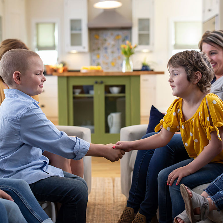 Two kids shaking hands
