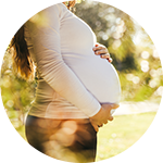 A pregnant woman holds her belly