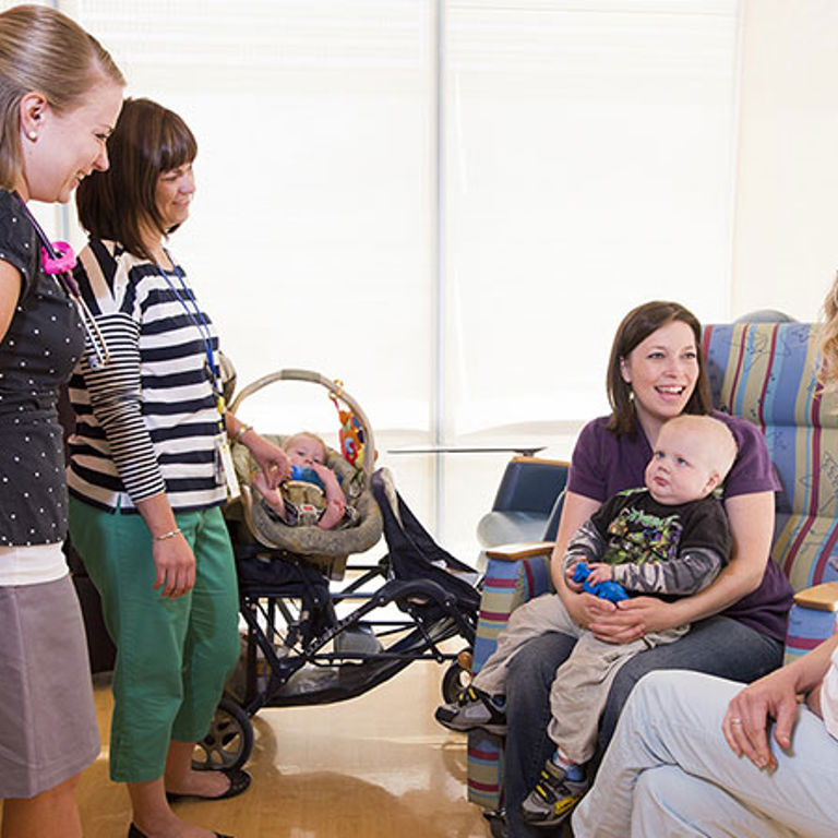 Mother and baby smiling in an appointment