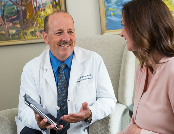Dr. Galan talks with a woman in the maternal fetal program.