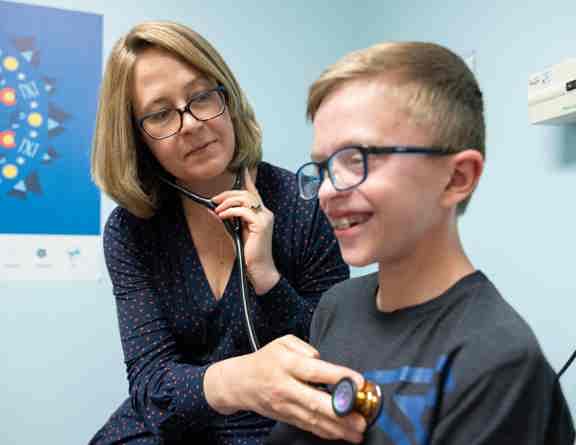 Dr. Kathryn Chatfield, a cardiac geneticist at Children’s Hospital Colorado, examines a pediatric heart patient.