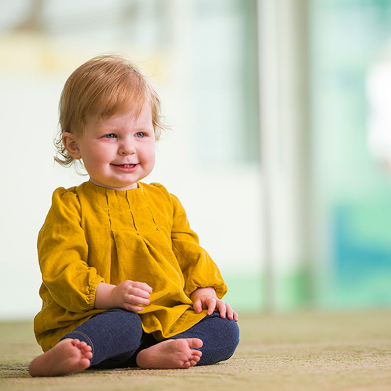 A one-year-old heart transplant recipient smiles for the camera.