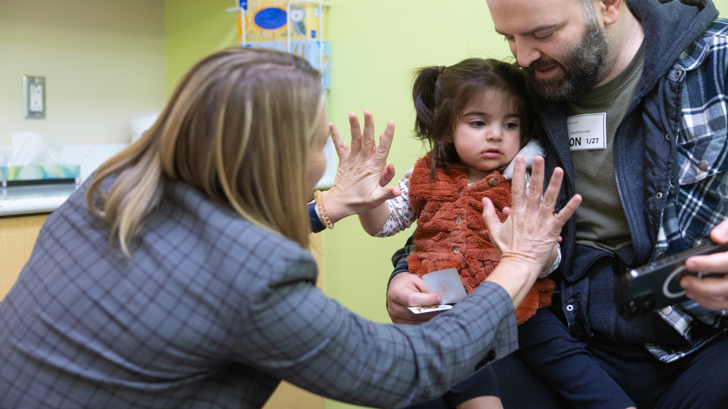 Person touching hand with a patient 