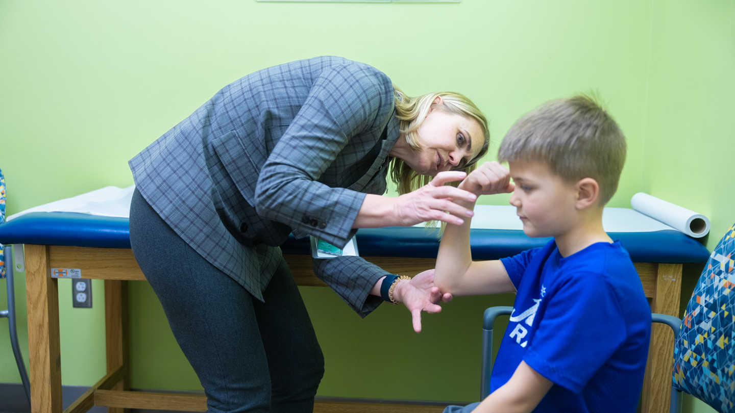 Person examining patient's arm 
