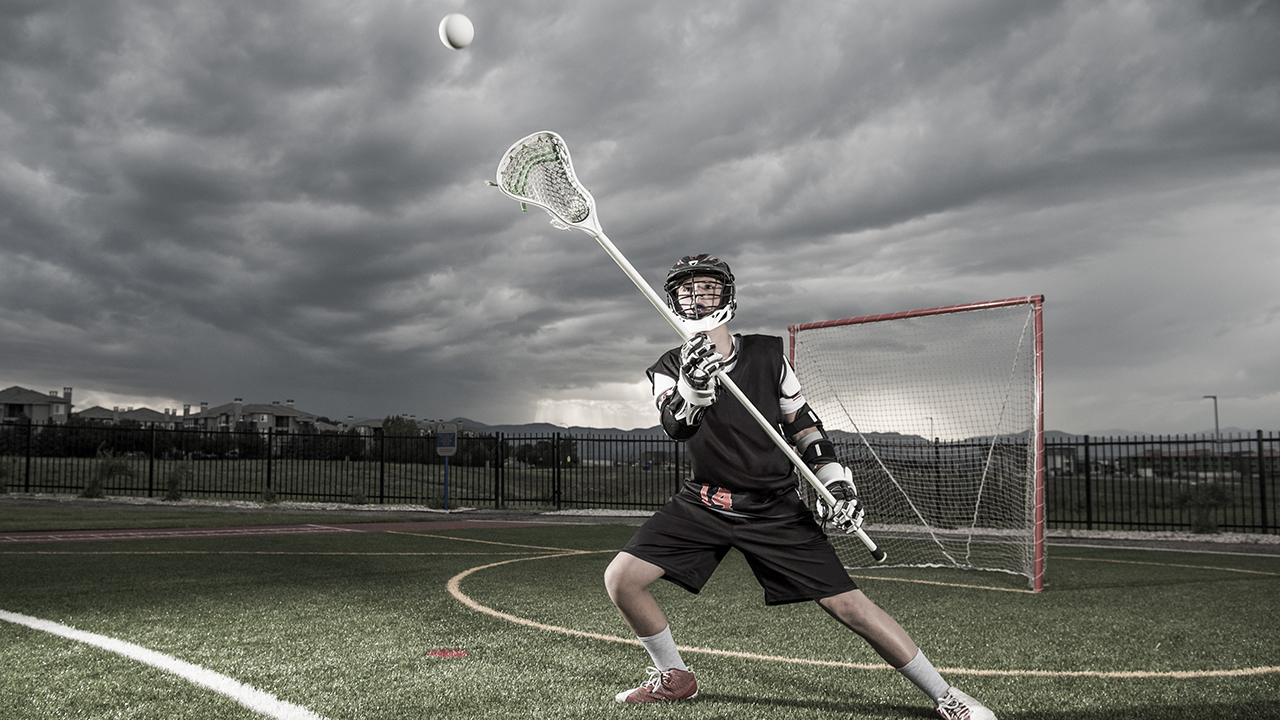 A lacrosse player catches the ball