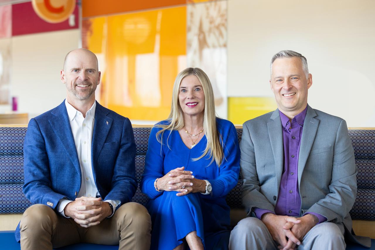 Charting Pediatrics hosts David Brumbaugh, MD, Alison Brent, MD and Dan Nicklas, MD sit together in a Children's Hospital Colorado waiting room.