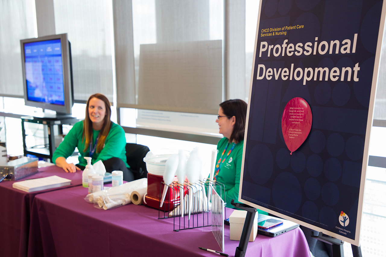 Health professionals gathered at a Magnet Fair booth discussing educational opportunities.