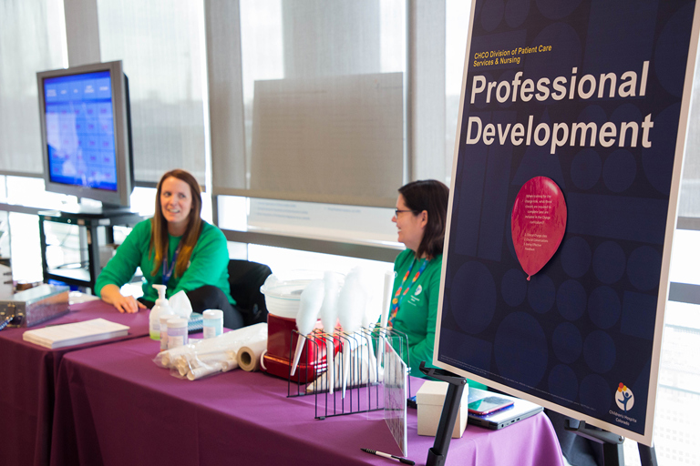 Health professionals gathered at a Magnet Fair booth discussing educational opportunities.