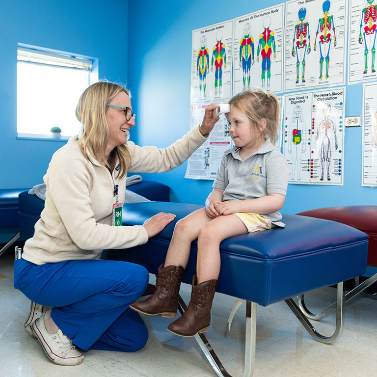 A school health nurse providing care to a student in a school setting.