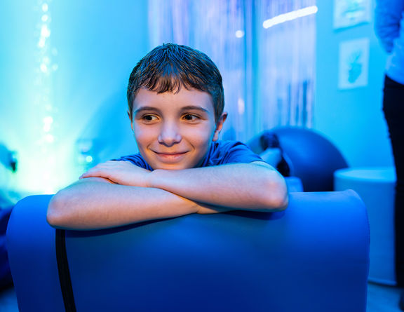 A clinician performing a compassionate mental health screening with a teenager.
