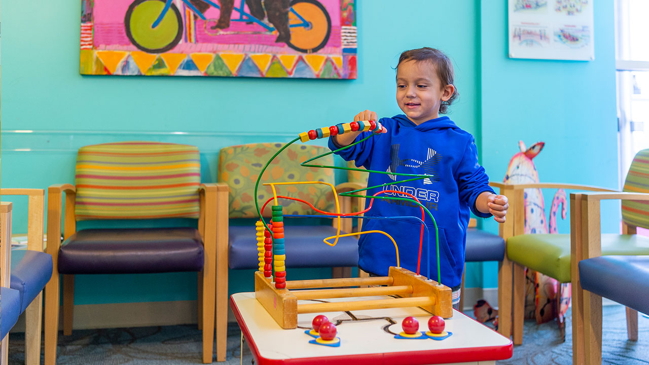 Patient playing in waiting room at Therapy Care, Broomfield