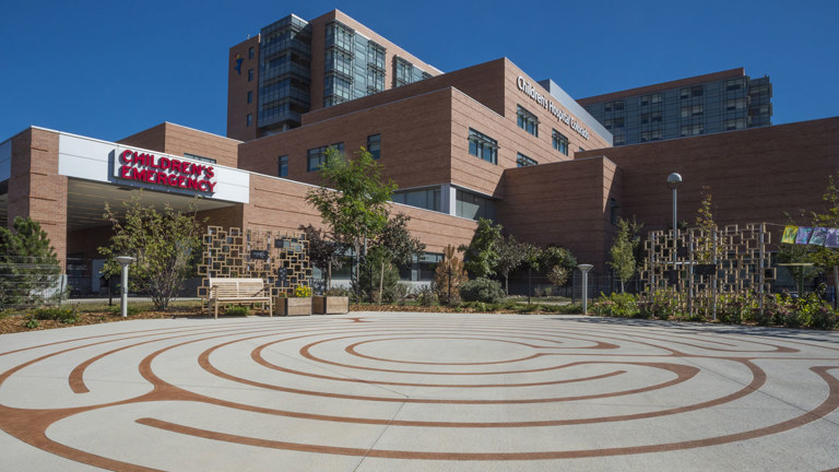 Hospital helipad located outside a children’s emergency entrance, with the main building behind it