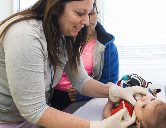 Physician doing check up on young child