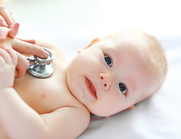baby laying with a stethoscope 
