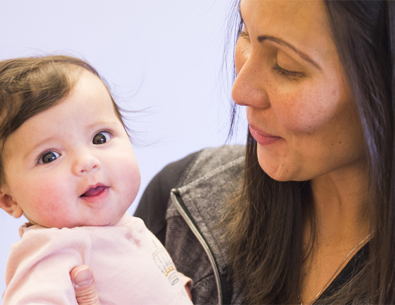 Photo of a mother looking at her infant child.