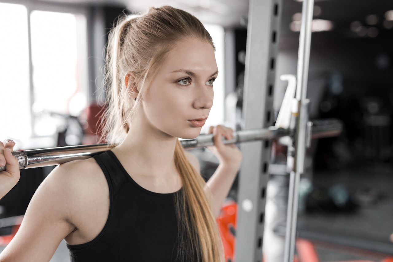 A team of high school football players walk across the field.