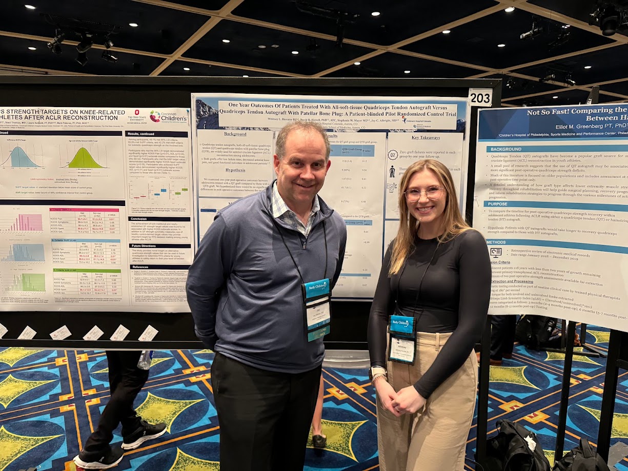 Whitney Hovater, BS, and Jay Albright, MD, in front of Whitney&rsquo;s poster entitled &ldquo;One Year Outcomes of Patients Treated with All-Soft-Tissue Quadriceps Tendon Autograft Versus Quadriceps Tendon Autograft With Patellar Bone Plug: A Patient-Blinded Pilot Randomized Control Trial.&rdquo;