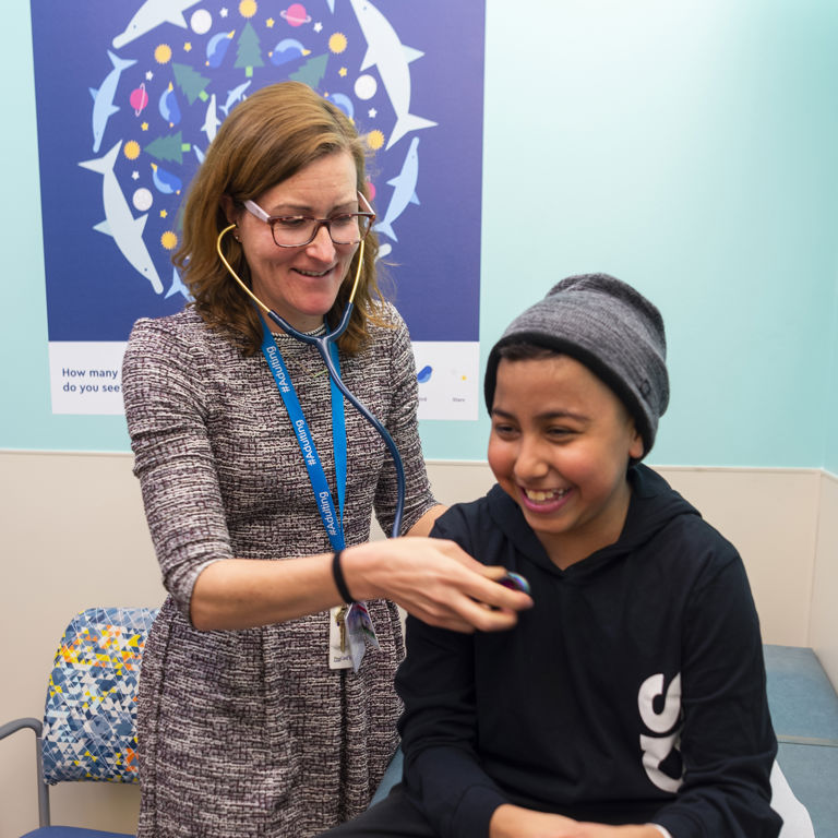Provider uses stethoscope on patient
