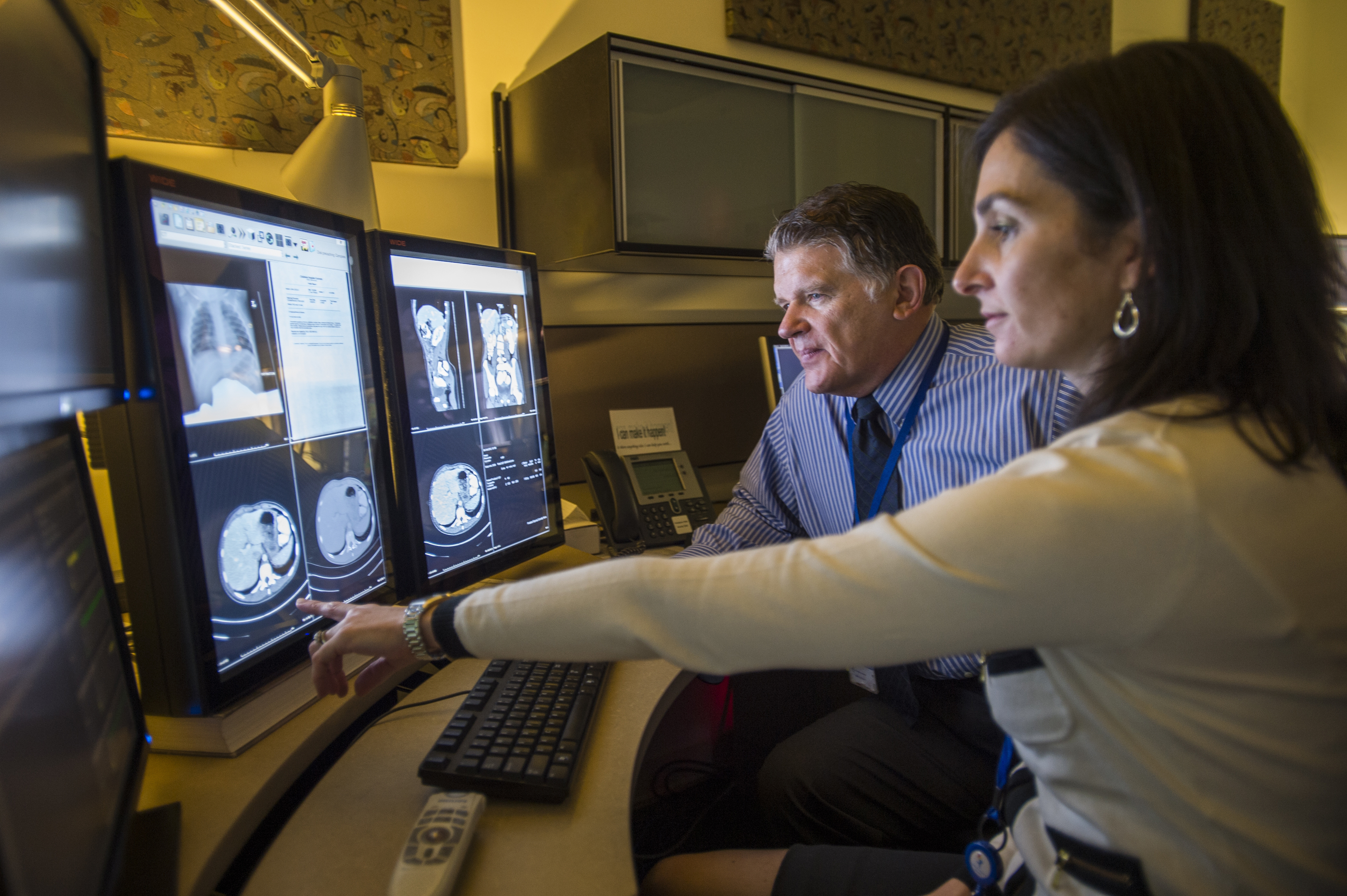 Doctors study MRI scans of the gastrointestinal area.