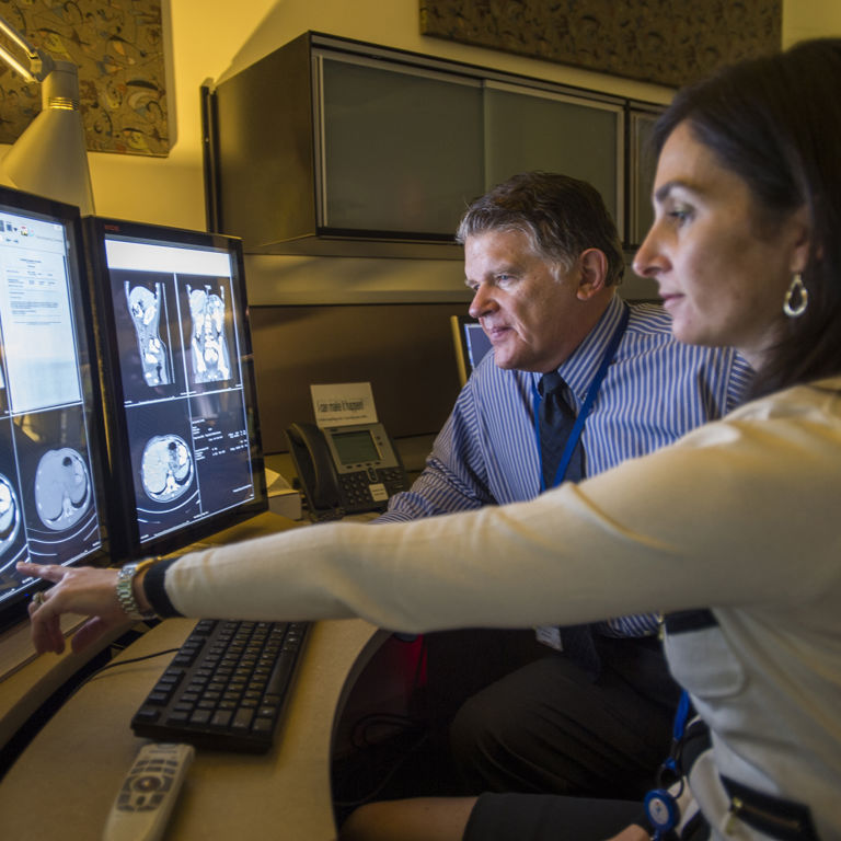 Doctors study MRI scans of the gastrointestinal area.