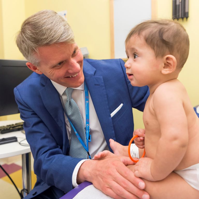 A urologist examines a young child.
